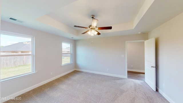 7908 Gardendale Dr, Olive Branch, MS 38654 - unfurnished room with a tray ceiling, visible vents, baseboards, and light carpet