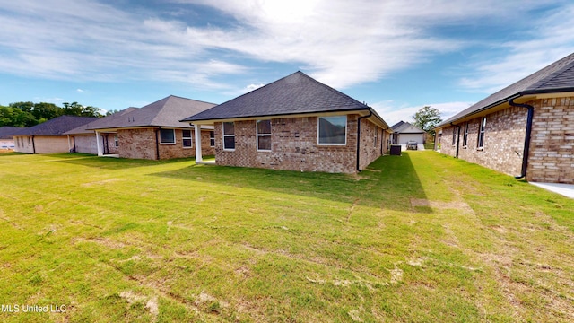 7908 Gardendale Dr, Olive Branch, MS 38654 - back of property with a yard, roof with shingles, and brick siding