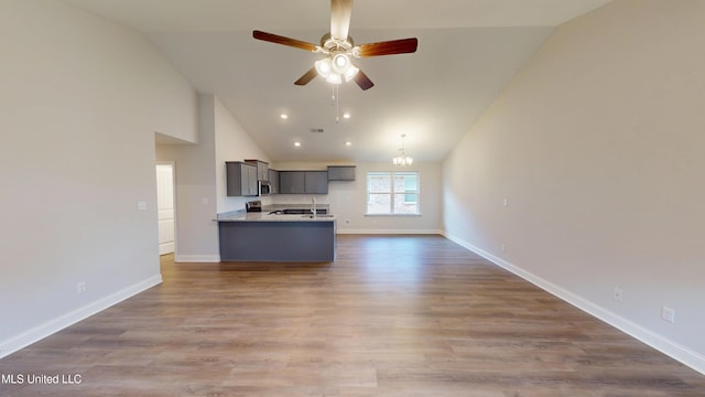 7908 Gardendale Dr, Olive Branch, MS 38654 - kitchen with stainless steel microwave, gray cabinets, ceiling fan, open floor plan, and baseboards