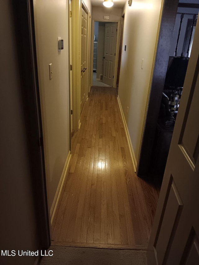 corridor with light hardwood / wood-style flooring