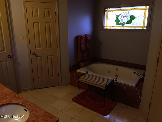 bathroom featuring vanity, a tub to relax in, and tile patterned flooring