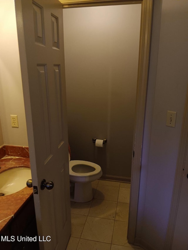 bathroom featuring vanity, toilet, and tile patterned flooring