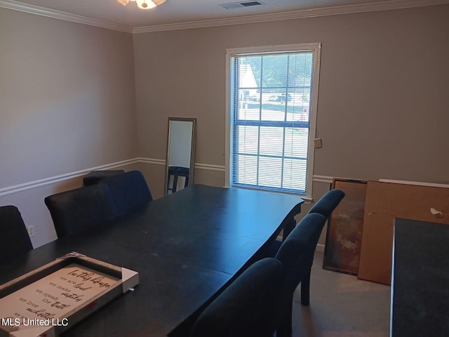 carpeted home office featuring crown molding