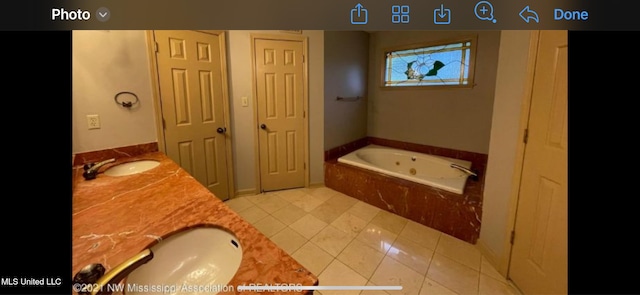 bathroom with vanity, tiled bath, and tile patterned floors