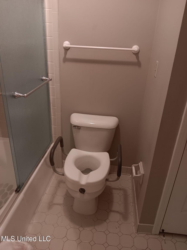 bathroom with bath / shower combo with glass door, toilet, and tile patterned flooring