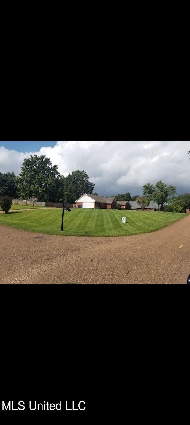 view of home's community with a lawn