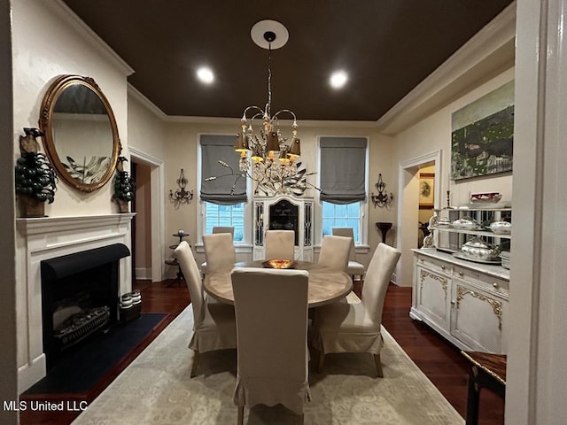 dining room with dark hardwood / wood-style flooring, ornamental molding, and an inviting chandelier