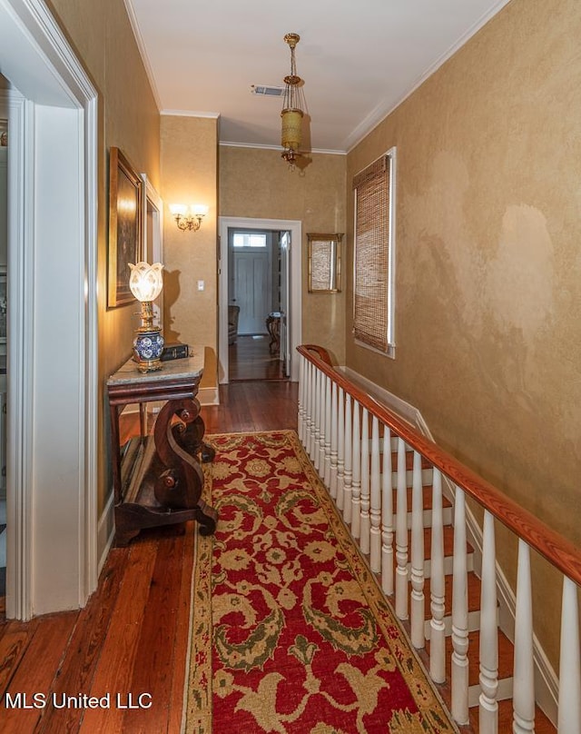 hall featuring ornamental molding and hardwood / wood-style flooring