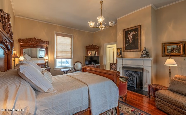 bedroom featuring hardwood / wood-style floors, an inviting chandelier, and crown molding