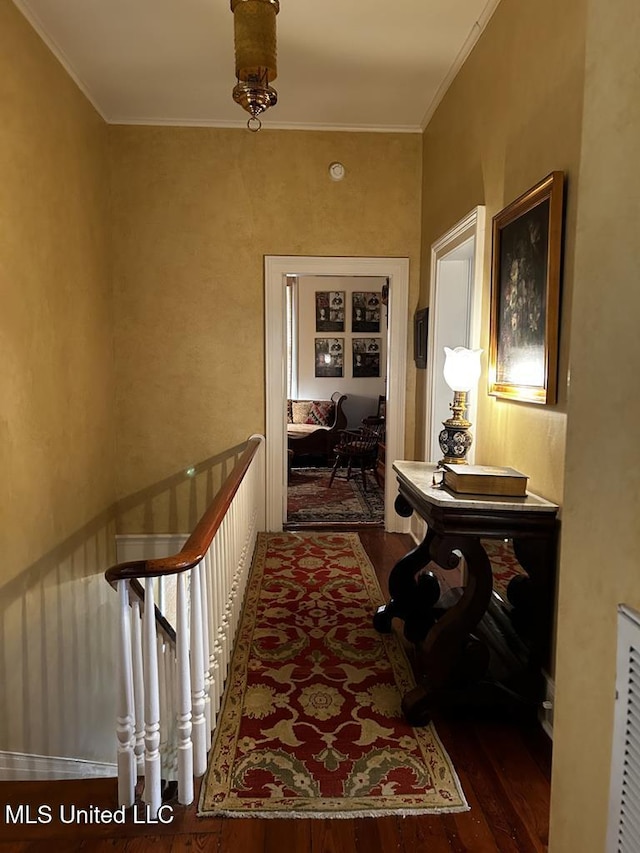 hall featuring dark hardwood / wood-style floors and ornamental molding