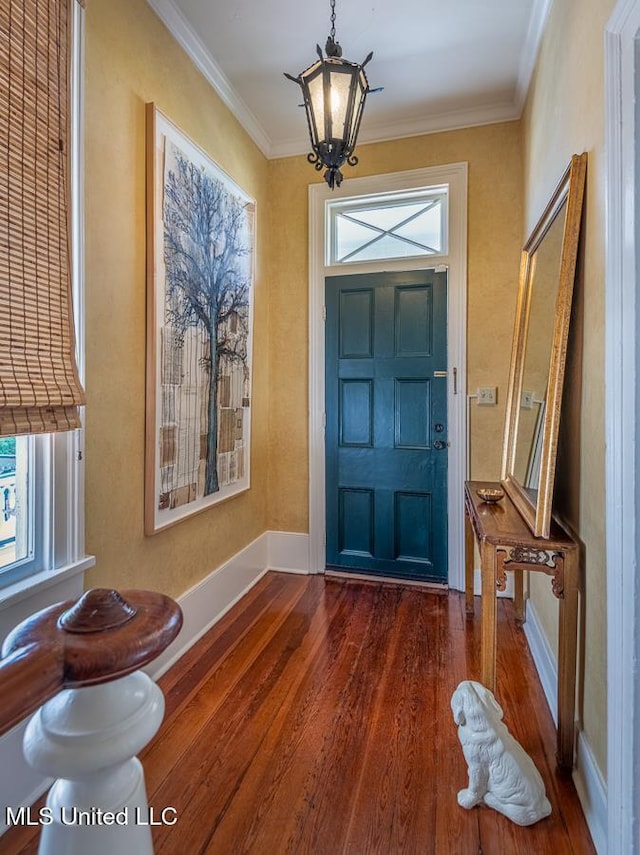 entrance foyer with crown molding, dark hardwood / wood-style floors, and a notable chandelier