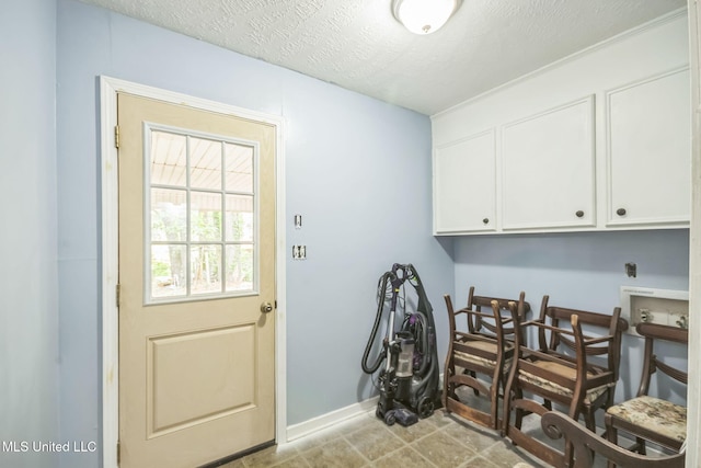 108 Fairdale Pl, Brandon, MS 39042 - laundry room featuring cabinet space, hookup for an electric dryer, and a textured ceiling