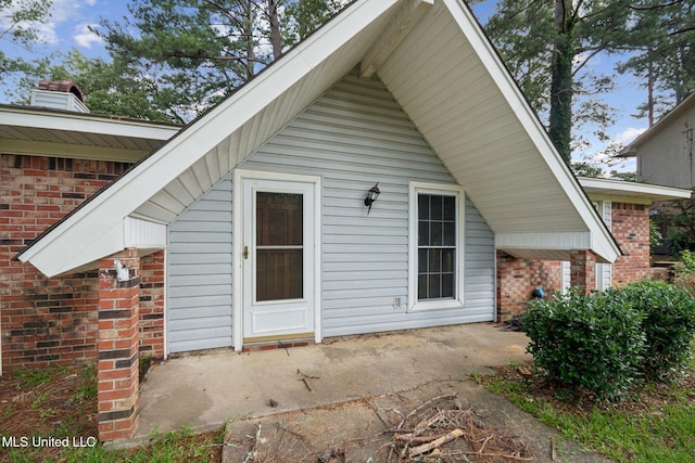 108 Fairdale Pl, Brandon, MS 39042 - back of house featuring brick siding, a patio, and a chimney