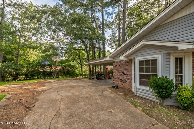 108 Fairdale Pl, Brandon, MS 39042 - view of side of home with concrete driveway and brick siding