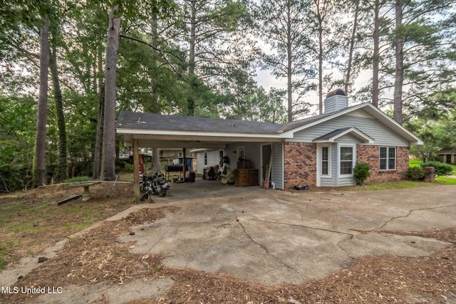 108 Fairdale Pl, Brandon, MS 39042 - view of home's exterior featuring a chimney, driveway, a carport, and brick siding