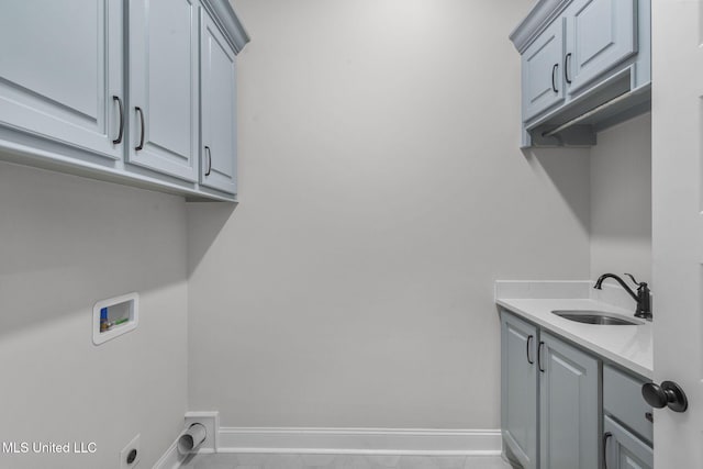 washroom featuring cabinets, washer hookup, hookup for an electric dryer, and sink