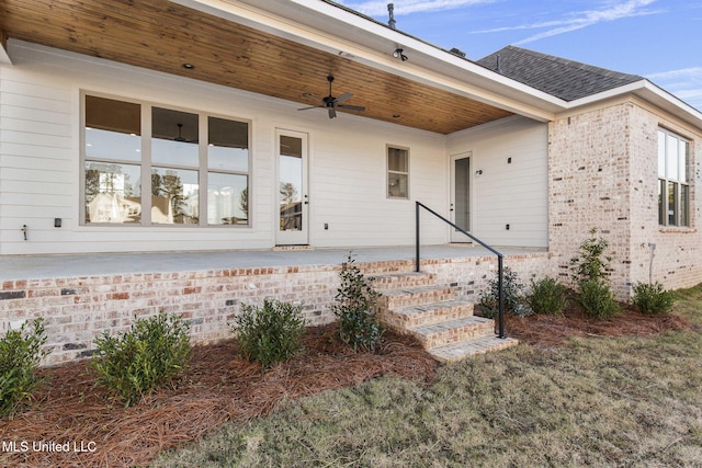 exterior space featuring ceiling fan and a lawn