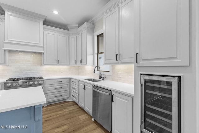 kitchen featuring wine cooler, white cabinetry, and stainless steel appliances