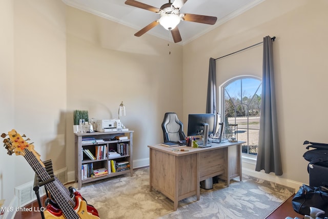 office featuring a ceiling fan, crown molding, and baseboards