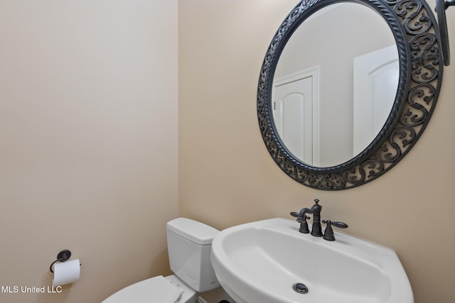 half bath with a sink and toilet