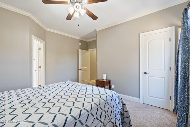 carpeted bedroom featuring crown molding, baseboards, and ceiling fan