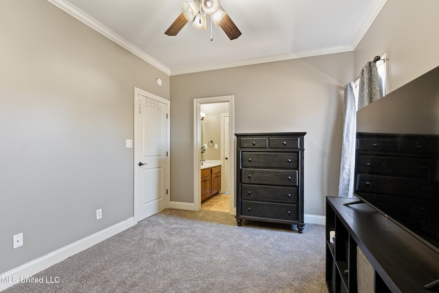 bedroom featuring crown molding, baseboards, ensuite bath, and light colored carpet