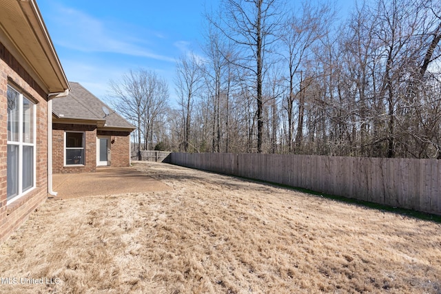 view of yard with a fenced backyard and a patio