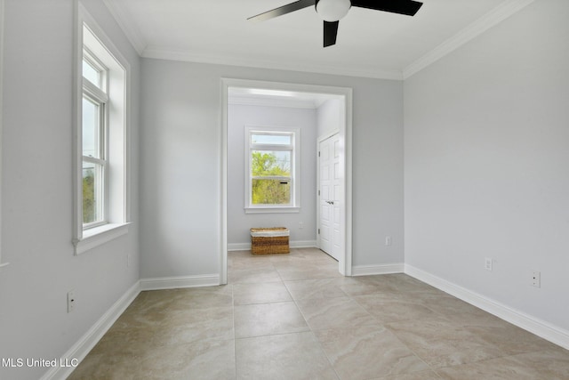 spare room with light tile patterned floors, crown molding, and ceiling fan