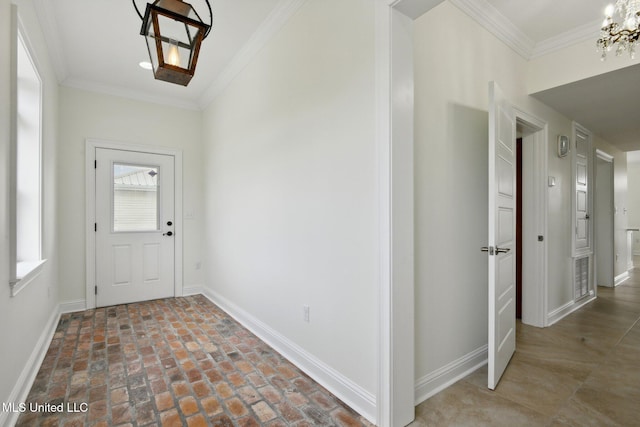 foyer entrance featuring ornamental molding and a notable chandelier