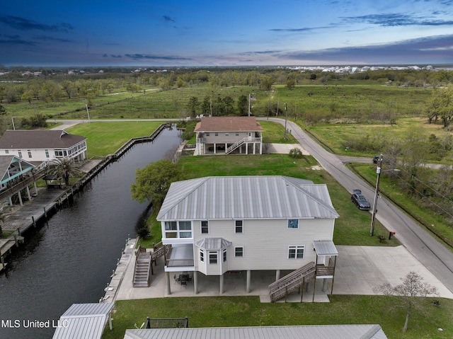 aerial view at dusk with a water view