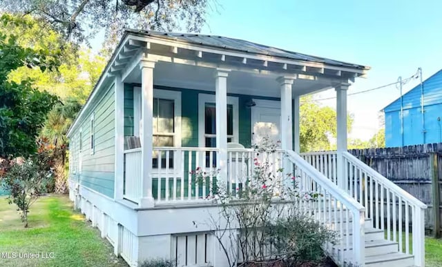 view of side of property with a porch