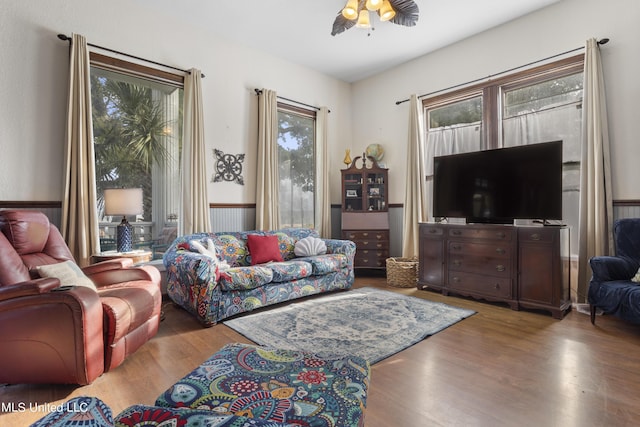 living room with wood finished floors and ceiling fan