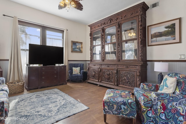 living area featuring wood finished floors and a ceiling fan