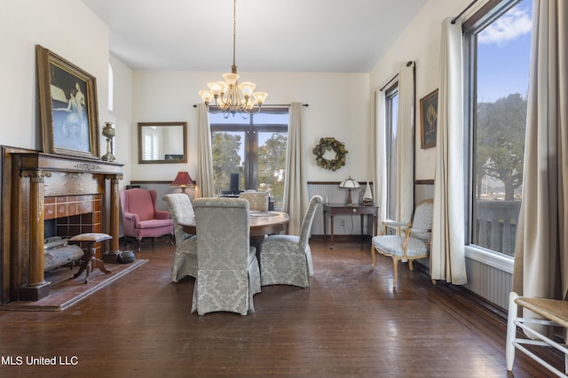 dining space with a chandelier and dark wood finished floors