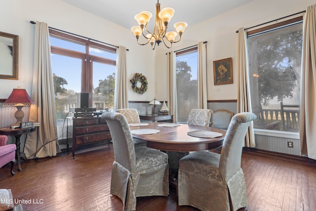 dining area with an inviting chandelier and dark hardwood / wood-style floors