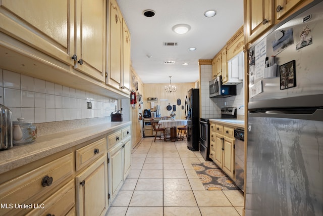 kitchen with hanging light fixtures, backsplash, light tile patterned flooring, a chandelier, and appliances with stainless steel finishes