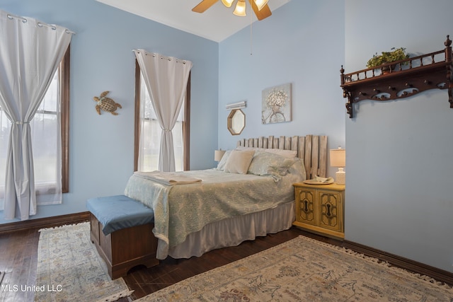 bedroom with wood finished floors, ceiling fan, and high vaulted ceiling