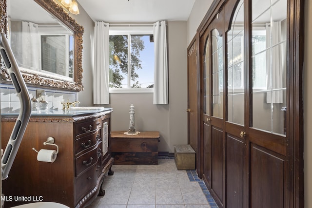 bathroom with tile patterned floors and vanity