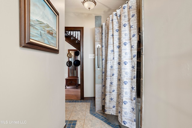 bathroom featuring tile patterned floors and a shower with curtain