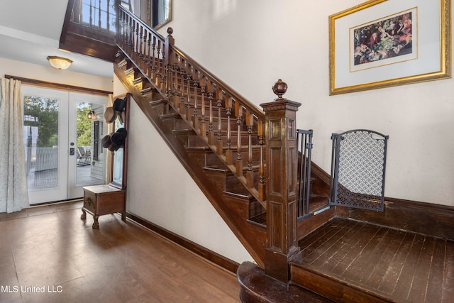 stairs with french doors and wood-type flooring