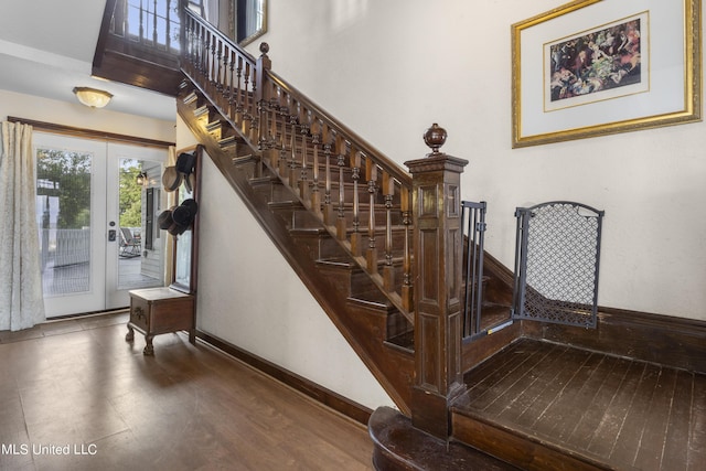 staircase featuring baseboards and wood finished floors