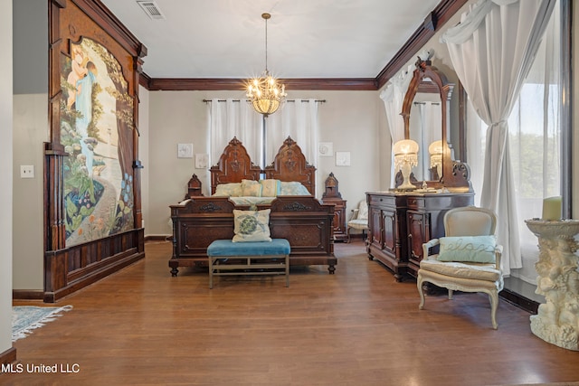 bedroom with a notable chandelier, ornamental molding, and hardwood / wood-style floors