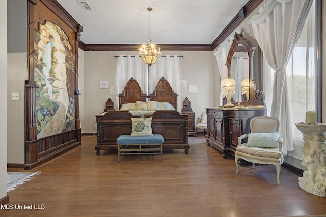 bedroom featuring a chandelier, wood finished floors, ornamental molding, and baseboards