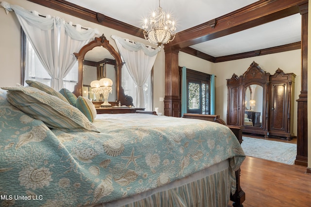 bedroom featuring crown molding, hardwood / wood-style flooring, beamed ceiling, and a notable chandelier