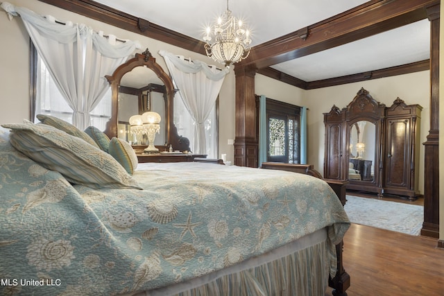 bedroom with a chandelier, crown molding, wood finished floors, and beamed ceiling