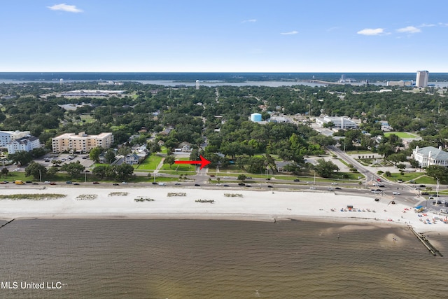 bird's eye view with a water view and a beach view