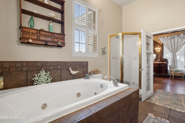 bathroom featuring a wealth of natural light and plus walk in shower