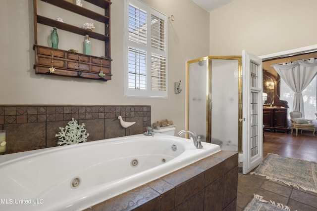 full bath with a stall shower, a jetted tub, and tile patterned floors