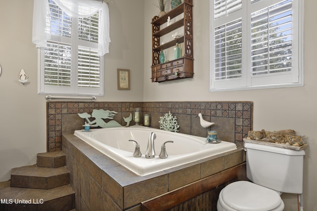 full bathroom with a bath and toilet