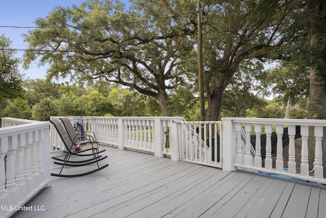 wooden terrace featuring view of scattered trees